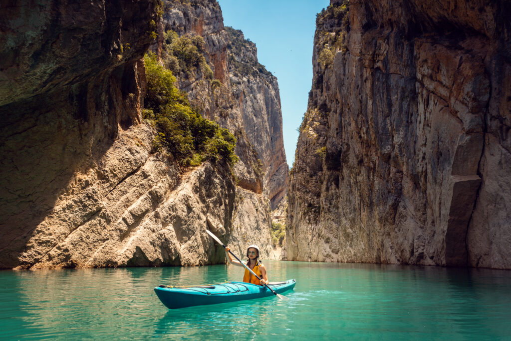 Woman On A Kayak In The Pyrenees Mountains In Catalonia
