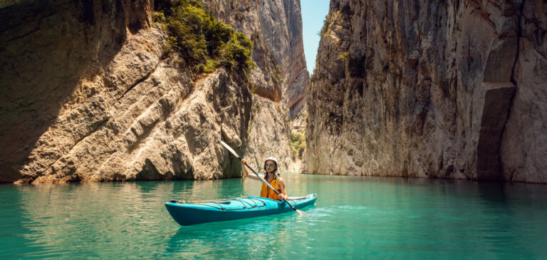 Woman On A Kayak In The Pyrenees Mountains In Catalonia